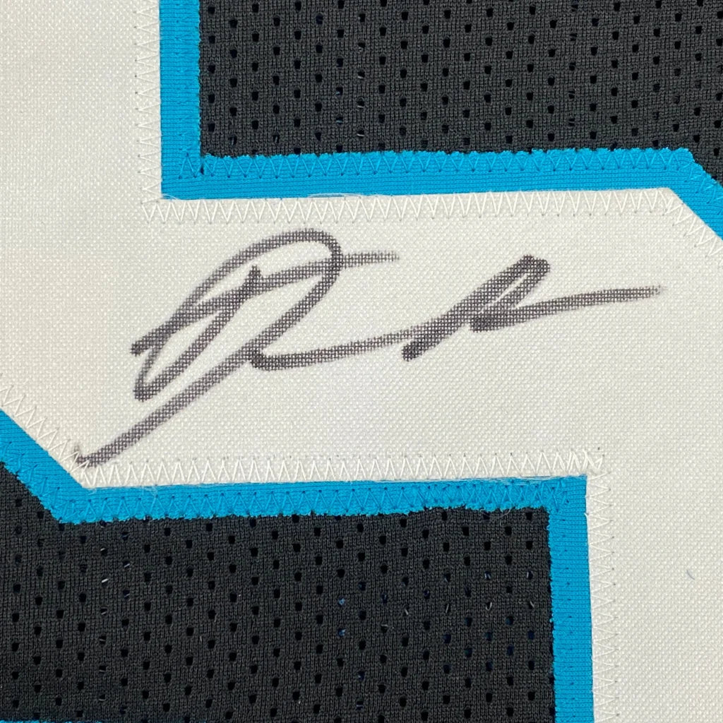 Autographed black and teal custom jersey from a professional sports league collectible