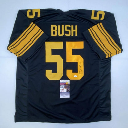 Back of a black and gold custom jersey with bush 55 in bold yellow lettering and three sleeve stripes professional sports league