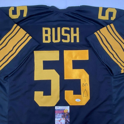 Back of navy blue and gold custom professional sports jersey with bush 55 in bold yellow and autograph lower right side