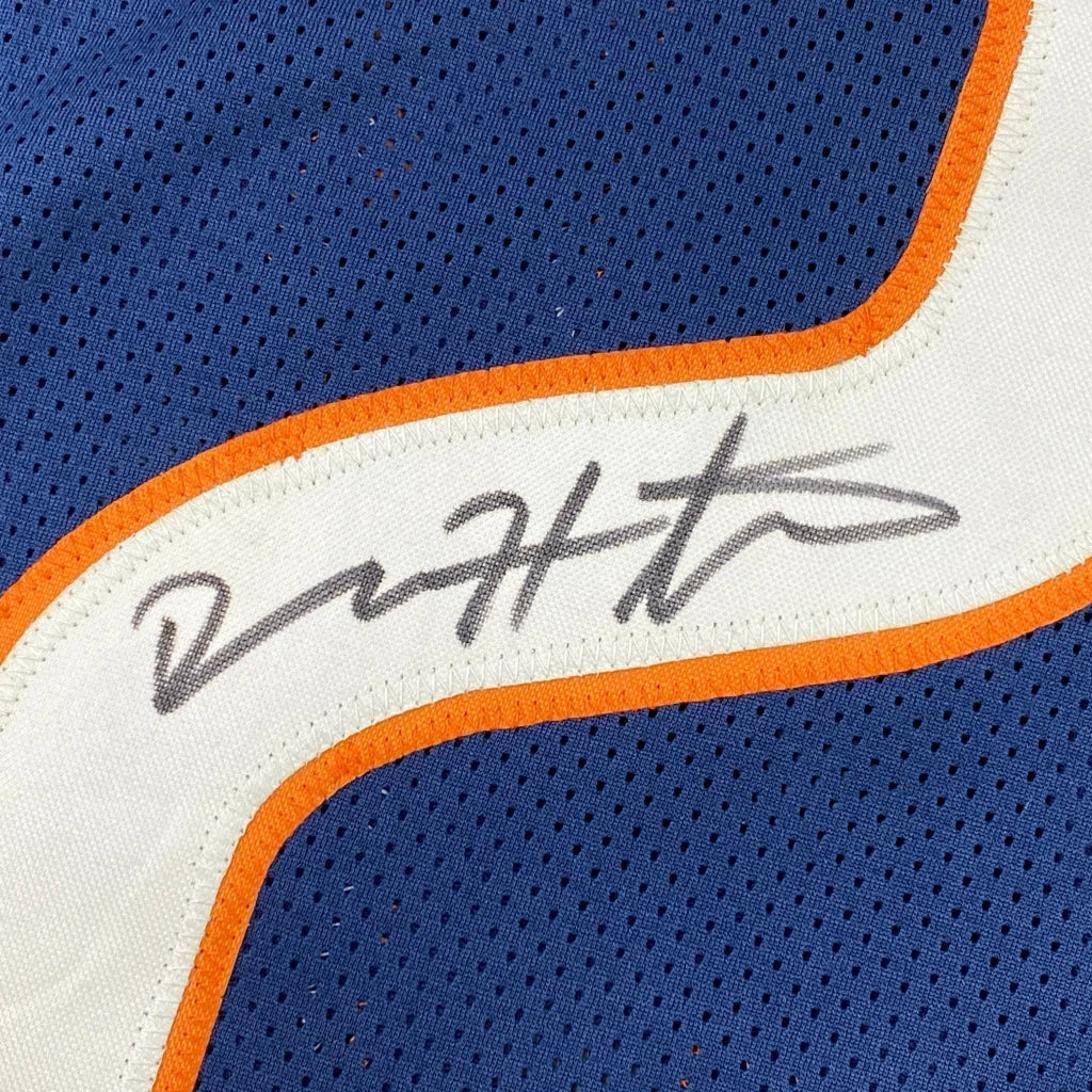 Blue custom jersey with orange and white trim and autograph from professional sports league