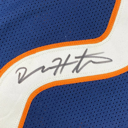 Blue custom jersey with orange and white trim and autograph from professional sports league