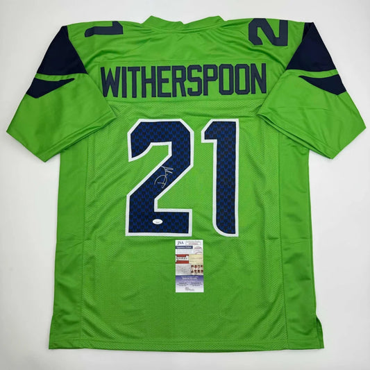Green football jersey with blue accents and autograph from Witherspoon 21 professional sports league