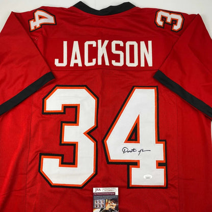 Red custom jersey signed by dexter jackson featuring white and orange lettering number 34 from professional sports league