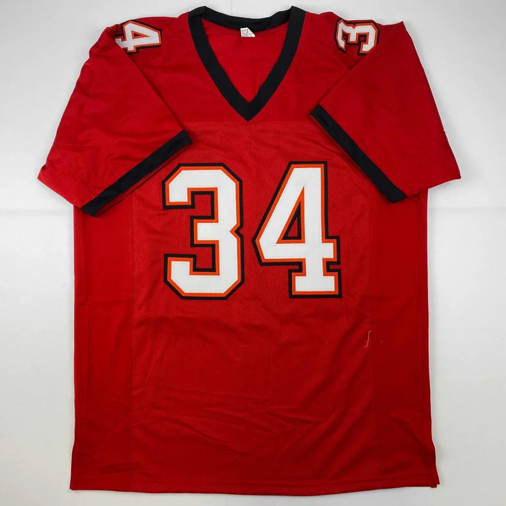 Red autographed dexter jackson tampa bay football jersey with black trim and white number 34 outlined in orange
