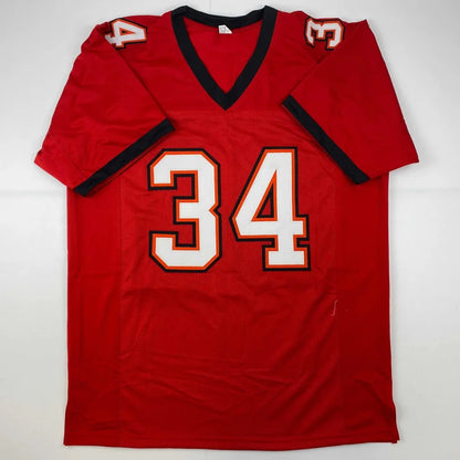 Red autographed dexter jackson tampa bay football jersey with black trim and white number 34 outlined in orange