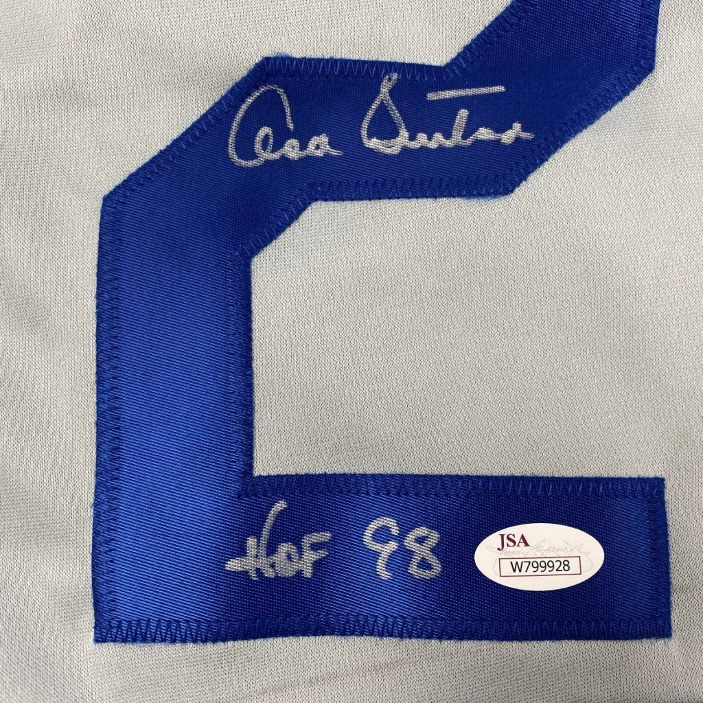 Blue number 2 embroidered on white fabric of Authentic Don Sutton custom jersey from professional sports league