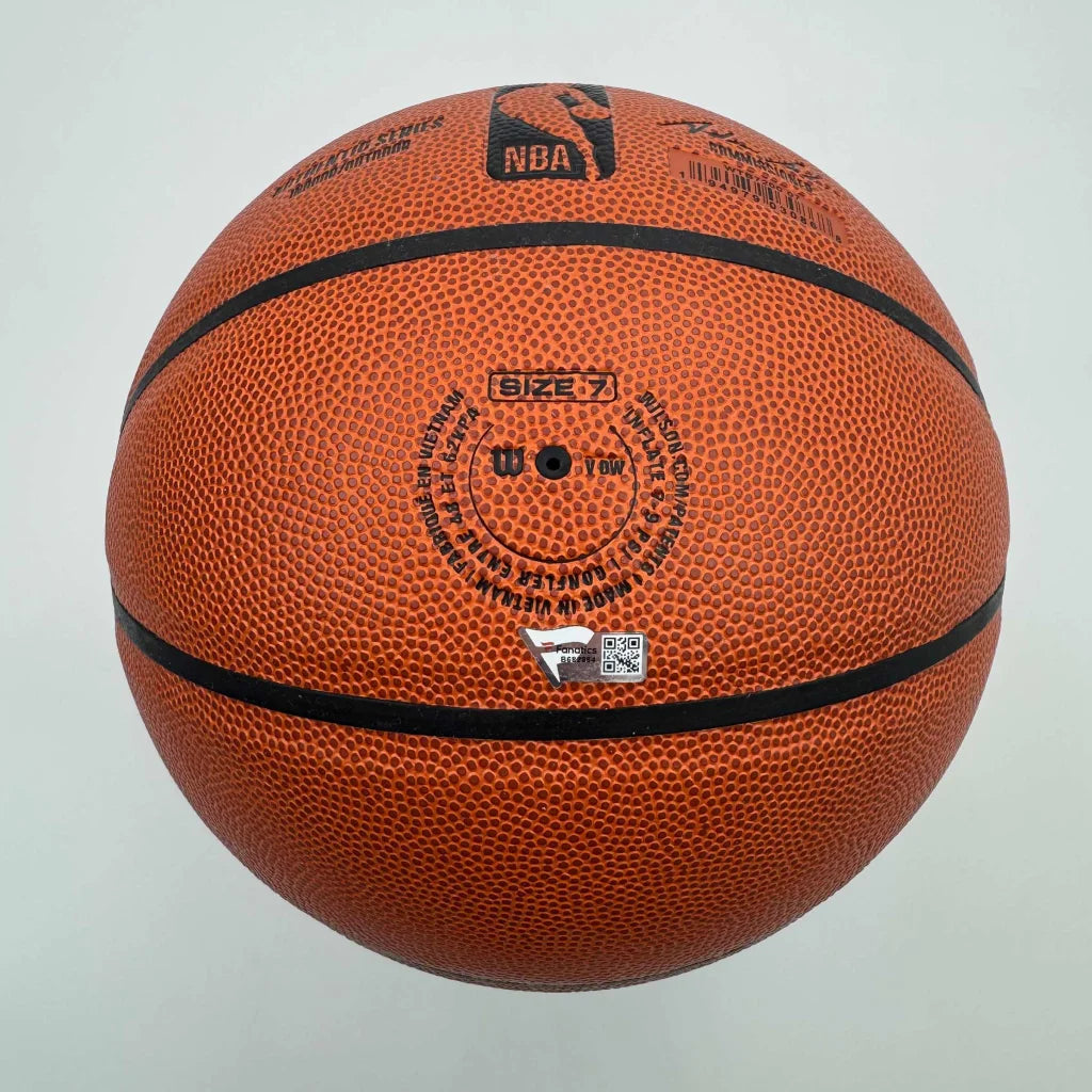 Orange textured Wilson basketball with black seams, autographed and authenticated