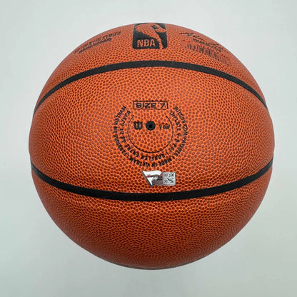 Orange textured Wilson basketball with black seams, autographed and authenticated