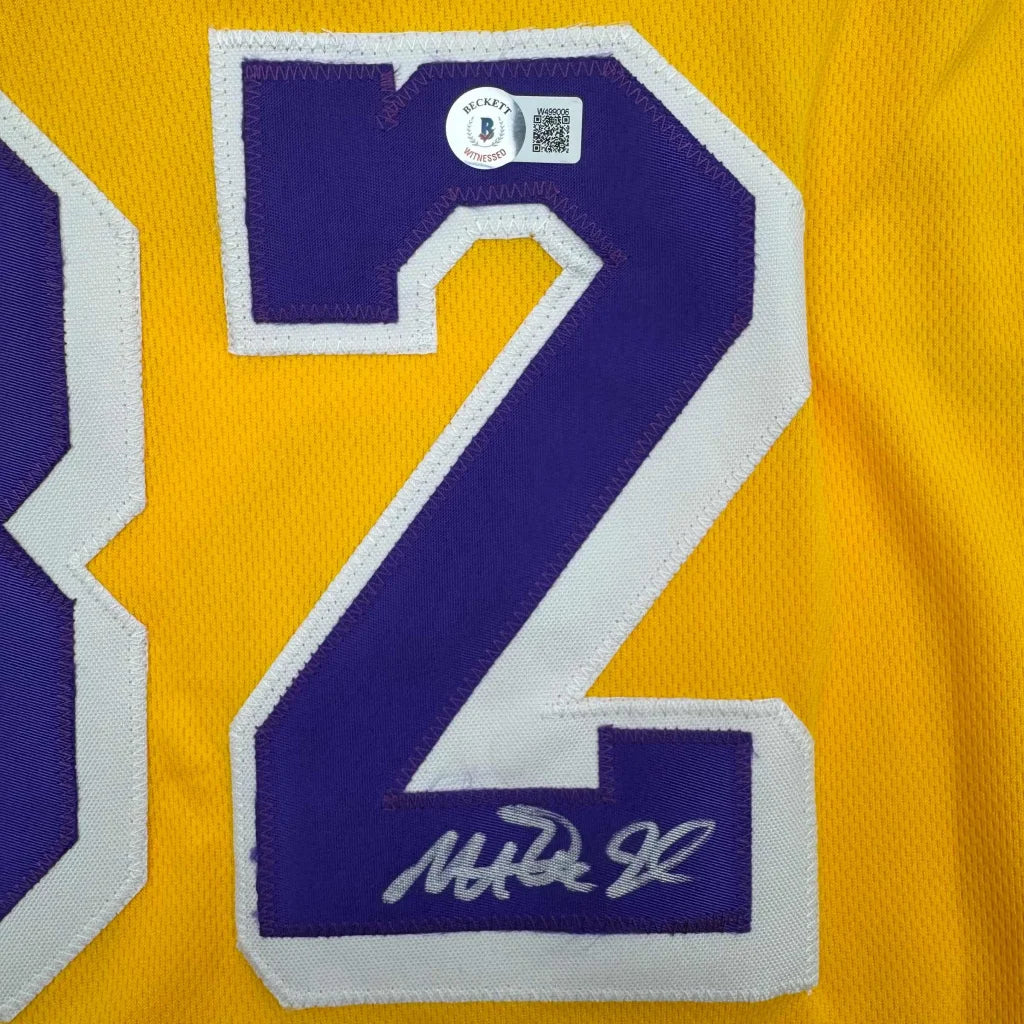 Yellow professional sports jersey with purple and white number 2 and signature