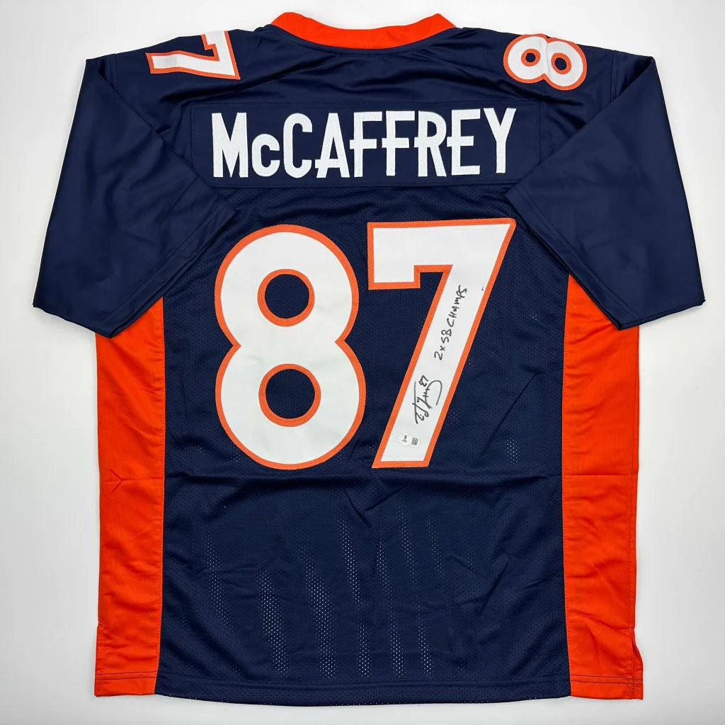 Autographed McCaffrey 87 dark blue and orange professional sports league jersey