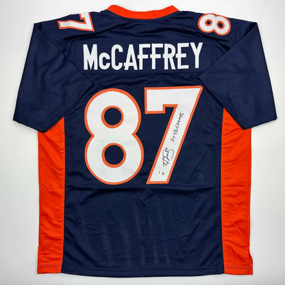 Autographed McCaffrey 87 dark blue and orange professional sports league jersey