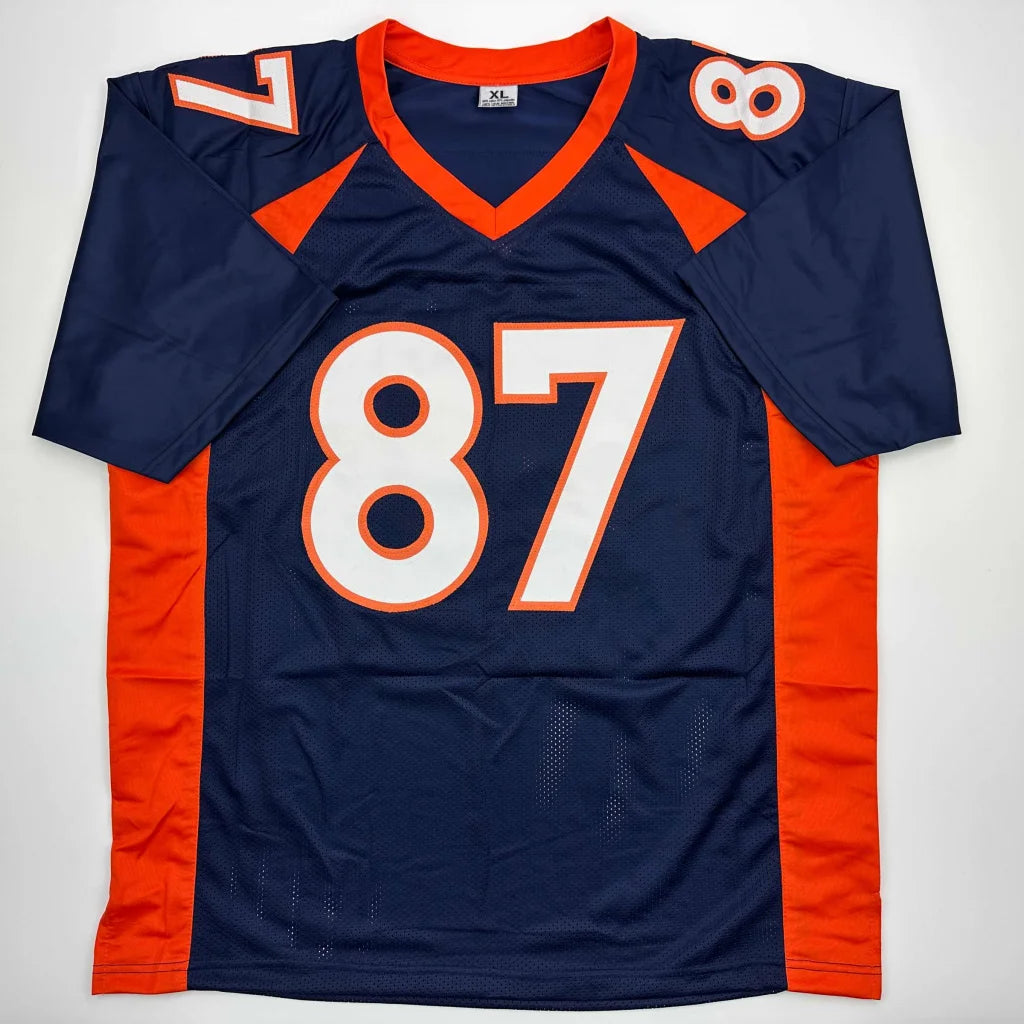 Autographed McCaffrey 87 dark blue and orange professional sports league jersey