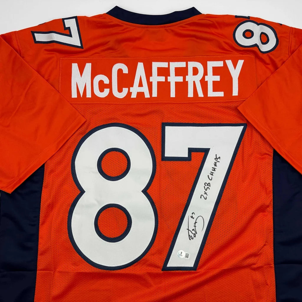 Autographed orange Denver Broncos Ed McCaffrey jersey from professional sports league collectible
