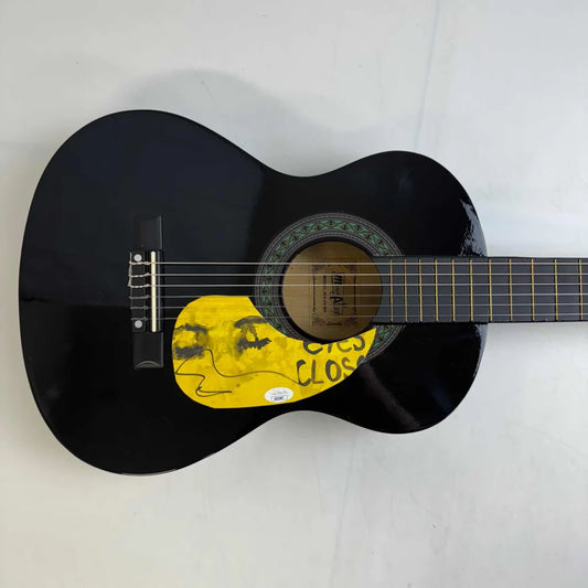 Black acoustic guitar with yellow pickguard showcasing third party authentication feature