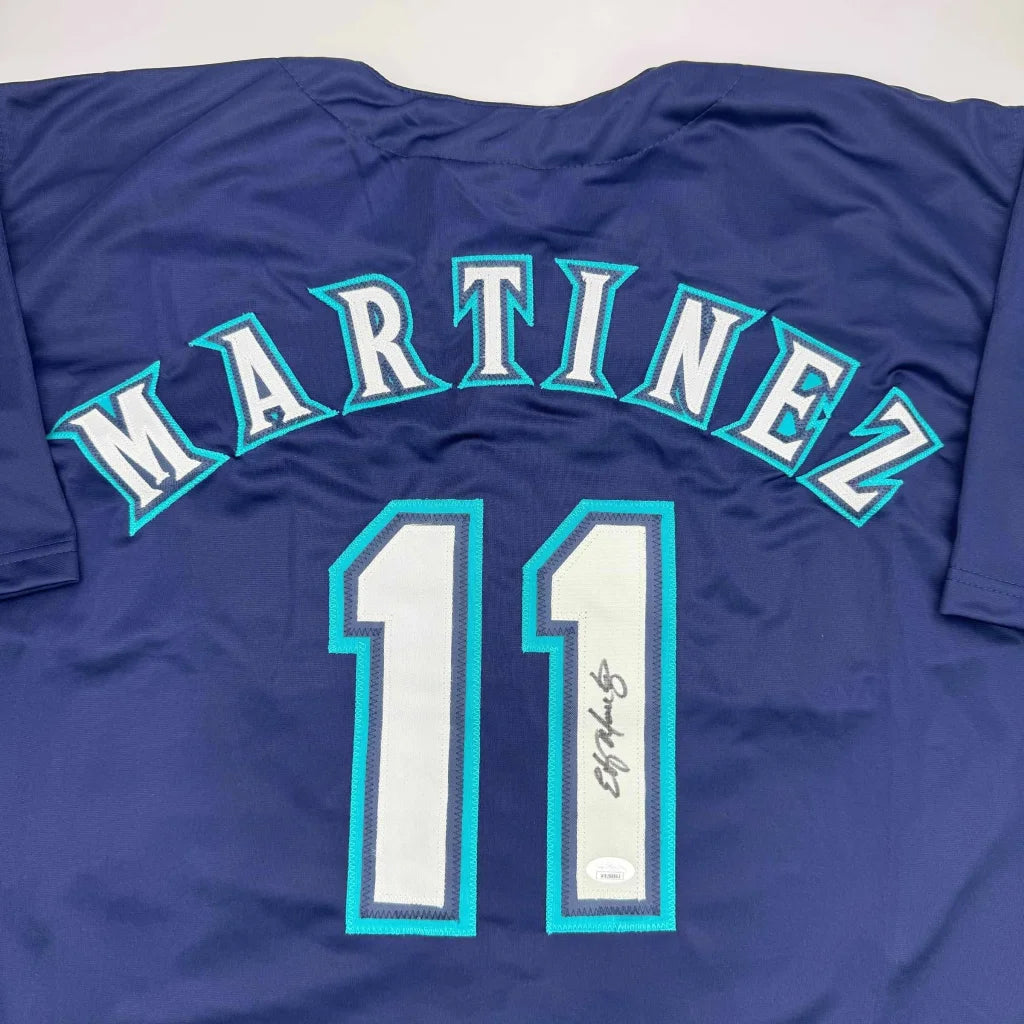 Navy blue professional sports league jersey with Martinez 11 autograph and teal white details