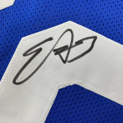 Autographed blue and white mesh custom jersey with black signature on white panel from professional sports league