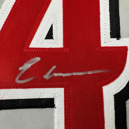 Red and white custom jersey with silver autograph from a professional sports league
