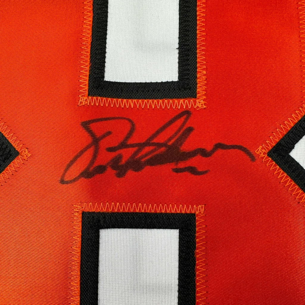 Autographed orange professional sports league custom jersey with white and black numbers