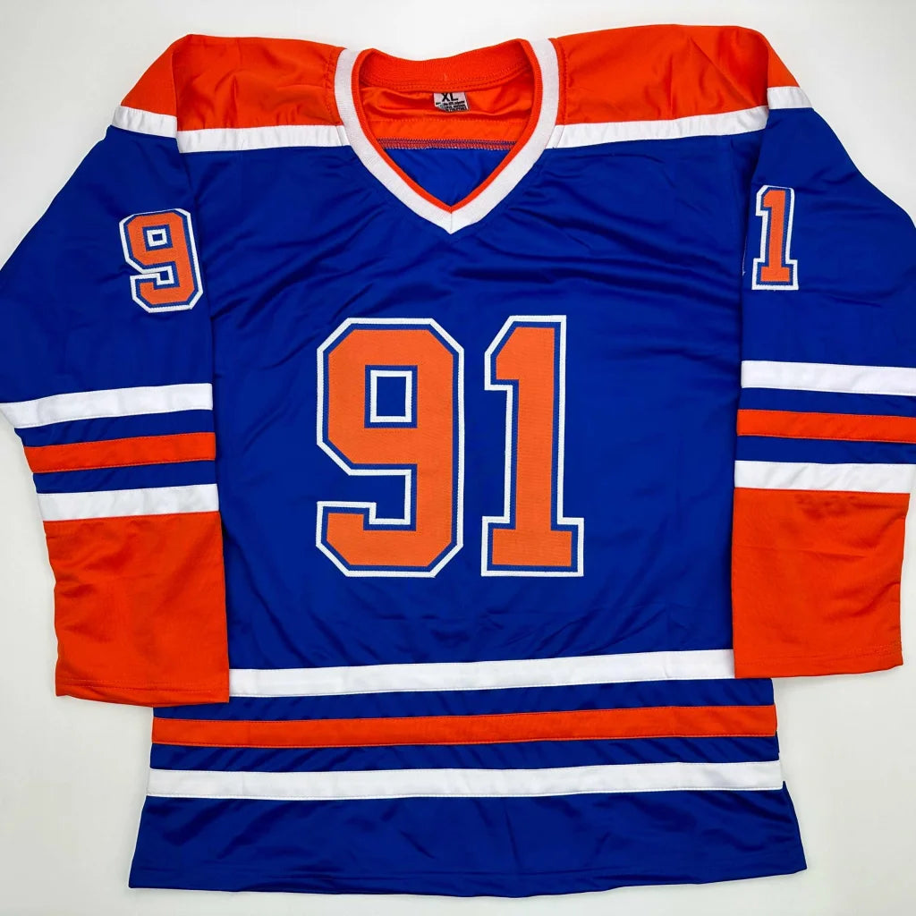 Blue hockey jersey with orange and white stripes and number 91 from professional sports league