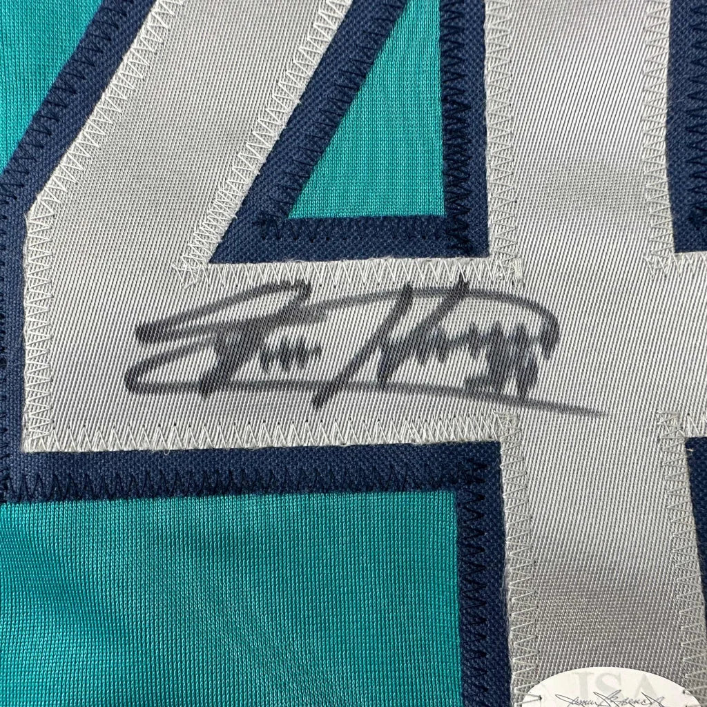 Autographed teal custom jersey with embroidered numbers from a professional sports league
