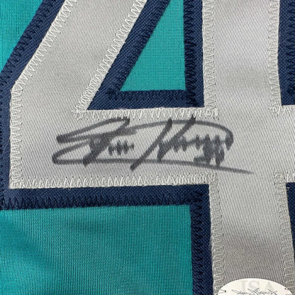 Autographed teal custom jersey with embroidered numbers from a professional sports league