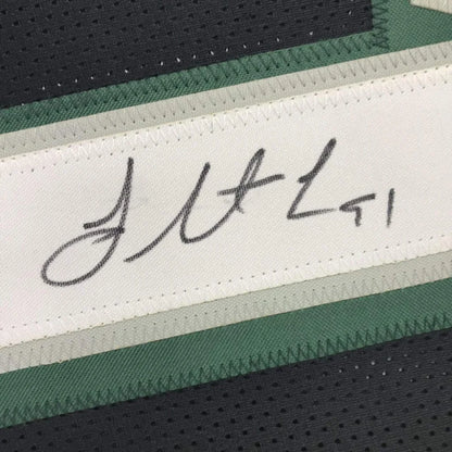 Black and green custom jersey with signature, perfect for professional sports fans