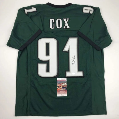 Dark green custom jersey with white numbers, autograph, and authentication sticker for professional sports league