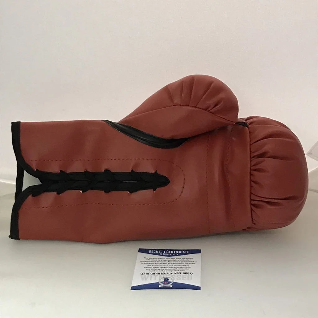 Autographed Floyd Mayweather Jr. red Everlast boxing glove with brown leather, black stitching, and laces. Beckett BAS COA