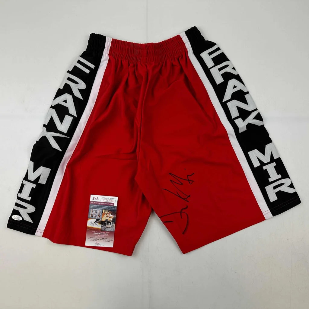 Red athletic shorts with black white side stripes and third party authentication