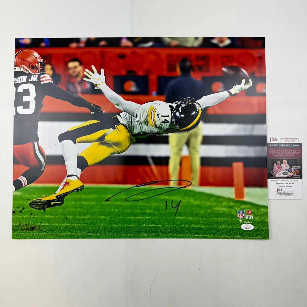 Autographed photo of a football player mid-air catching a ball for Authenticated Mid Air Football Catch product