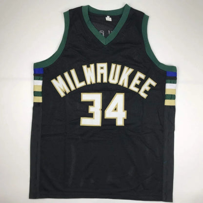 Black Milwaukee Bucks custom jersey with green trim and gold accents from professional sports league