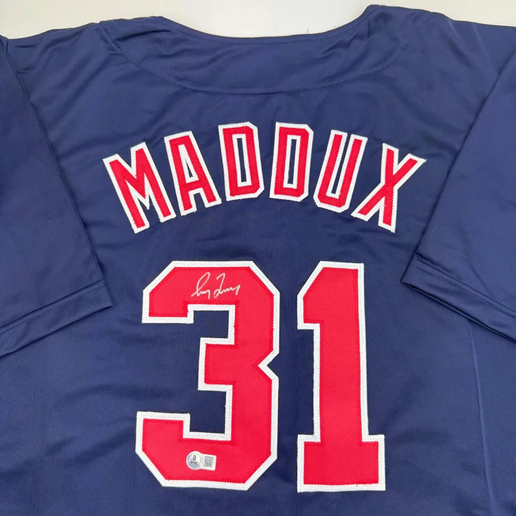 Autographed Greg Maddux Atlanta Blue Professional Sports Jersey displayed for fans