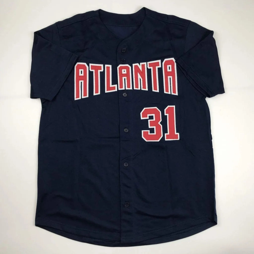 Navy blue short-sleeled Greg Maddux Atlanta professional sports autographed jersey with red and white lettering