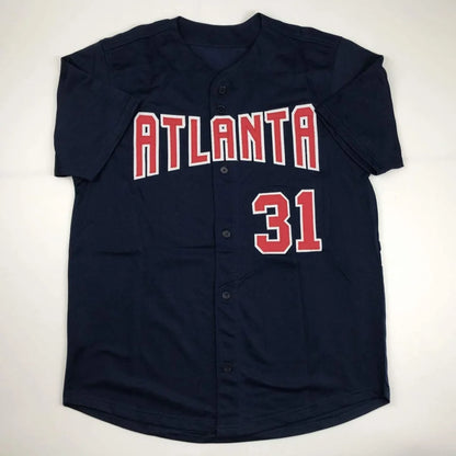 Navy blue short-sleeled Greg Maddux Atlanta professional sports autographed jersey with red and white lettering