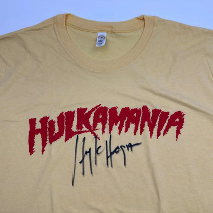 Autographed Hulk Hogan Hulkamania beige cotton T-shirt with red lettering and black signature, Beckett BAS COA