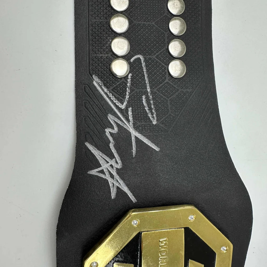 Autographed Israel Adesanya black UFC replica belt with gold plaque