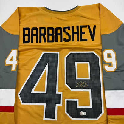 Gold and gray custom hockey jersey with number 49 and signature from professional sports league