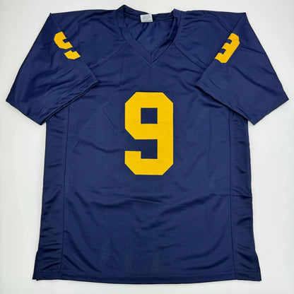 Navy blue custom jersey with gold number 9 for professional sports fans in a sports league