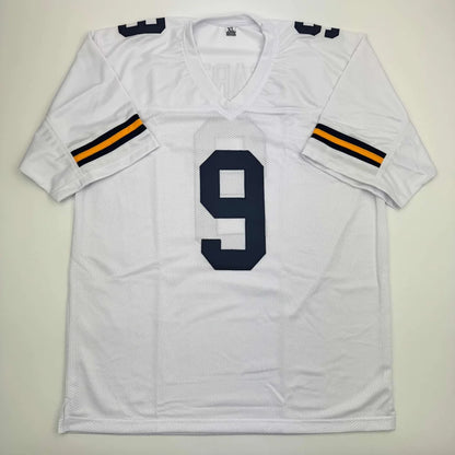 Autographed J.J. McCarthy white custom jersey with navy 9, Michigan college football