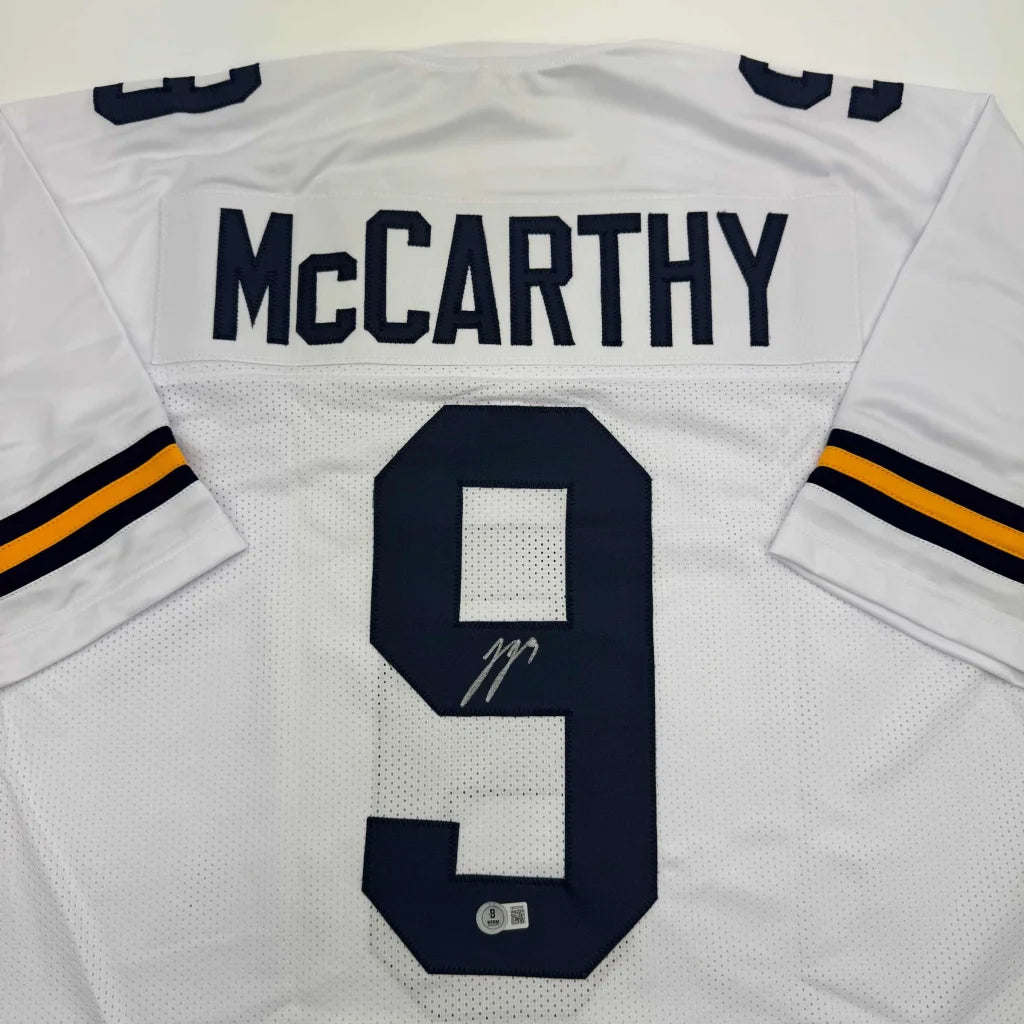 Back of autographed J.J. McCarthy custom Michigan white football jersey number 9
