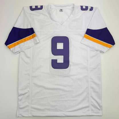 White and purple number 9 sports jersey with gold stripes from Authentic McCarthy professional sports league