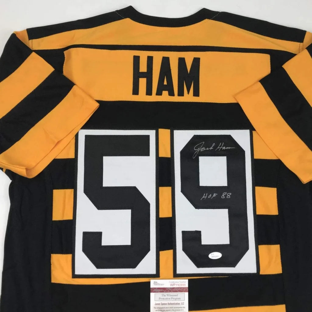 Image of the back side of a black and yellow autographed jack ham hof 88 custom jersey from a professional sports league