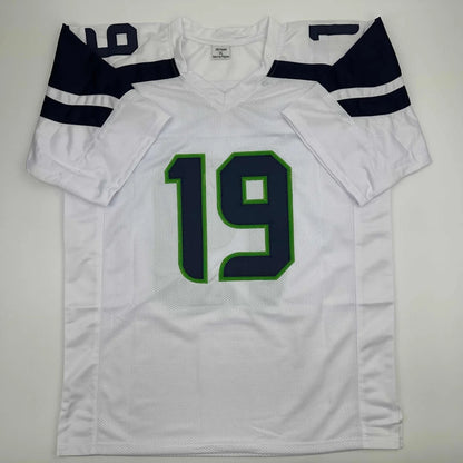 White American football jersey with navy blue and green accents, number 19, custom jersey for professional sports league