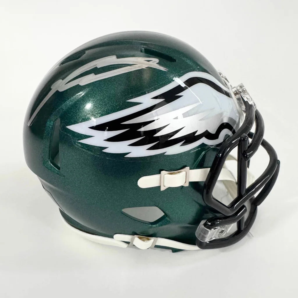Green football helmet with silver eagle wing logo and black facemask, third party authentication