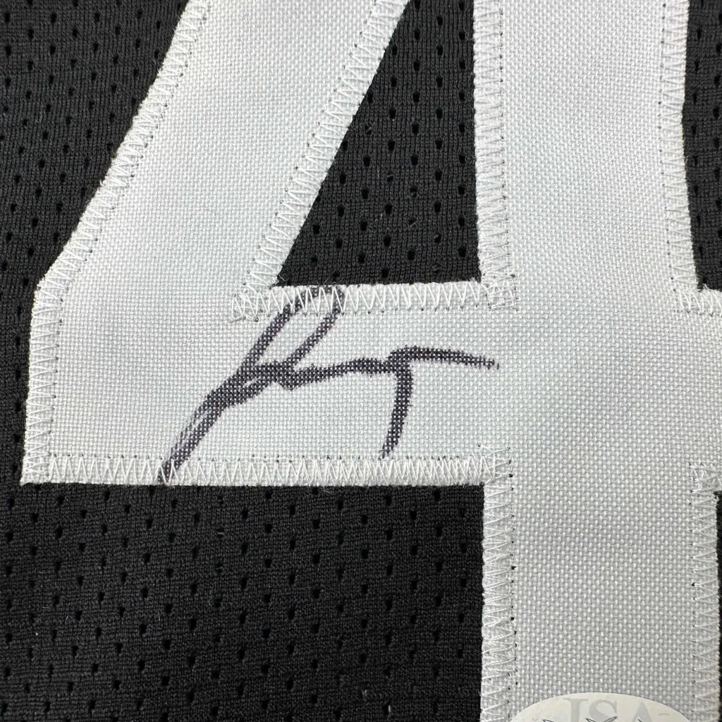 Black sports jersey with white 4 number and autograph from a professional sports league