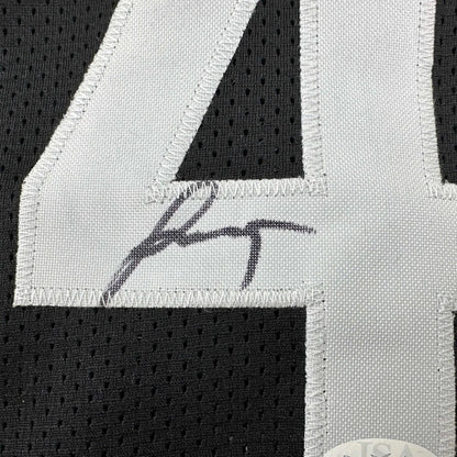 Black sports jersey with white 4 number and autograph from a professional sports league