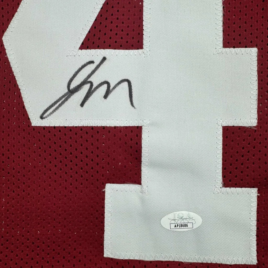 Red Custom Jersey with white numbers and black autograph, perfect sports memorabilia