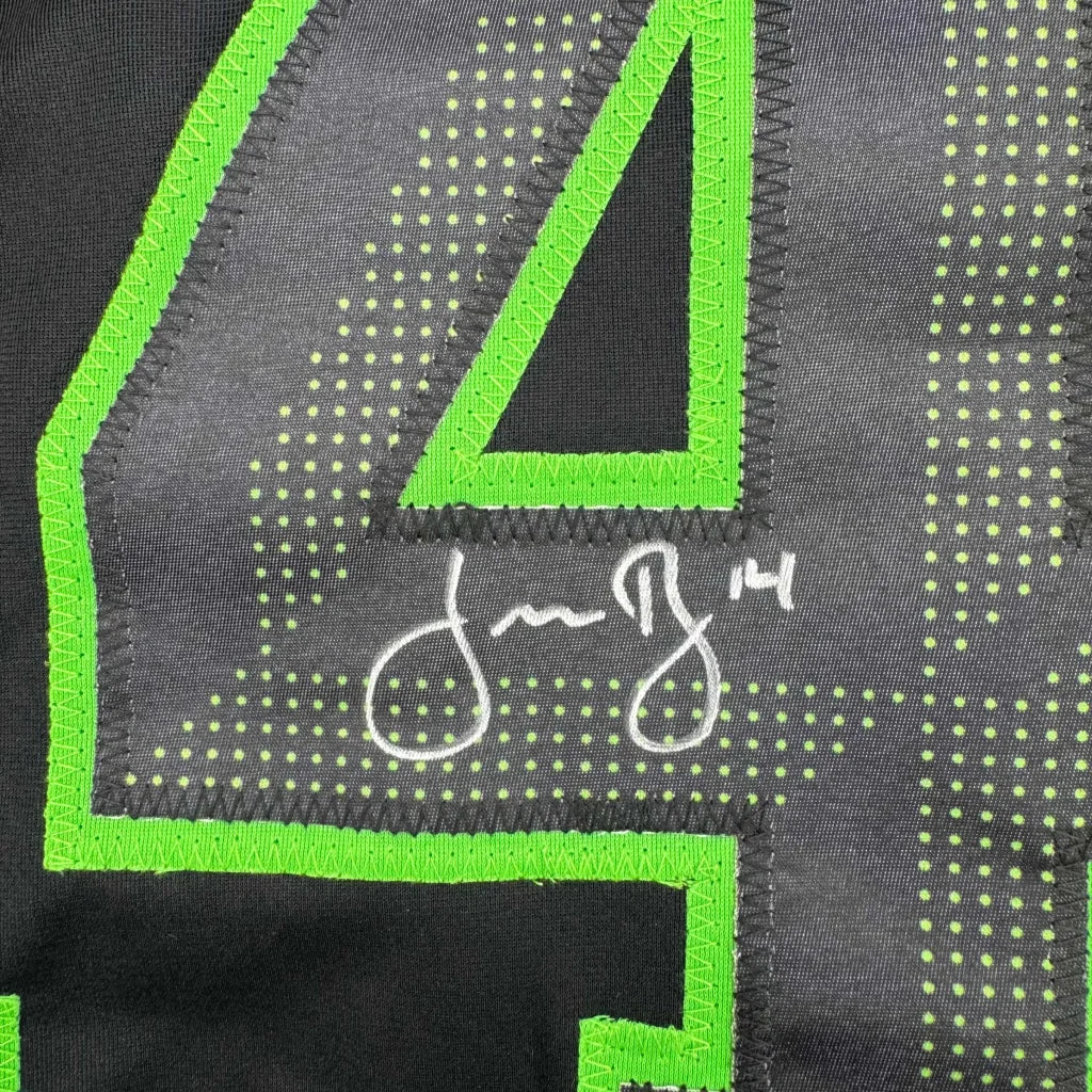 Back of black custom jersey with neon green number 4 and white signature from professional sports league player Jamie Benn
