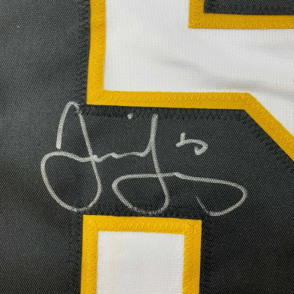 Black and yellow custom jersey with white autograph from a professional sports legend