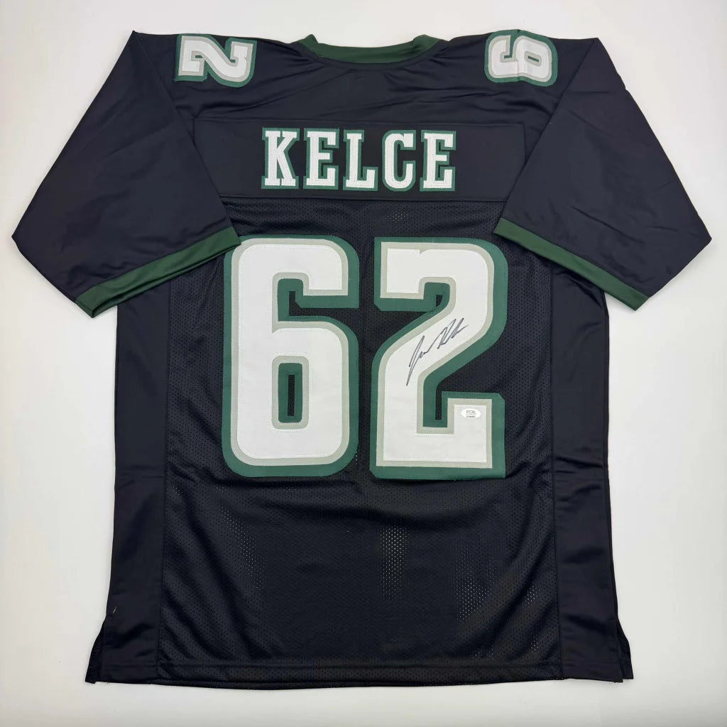 Black KELCE custom jersey with green trim and signature from professional sports league